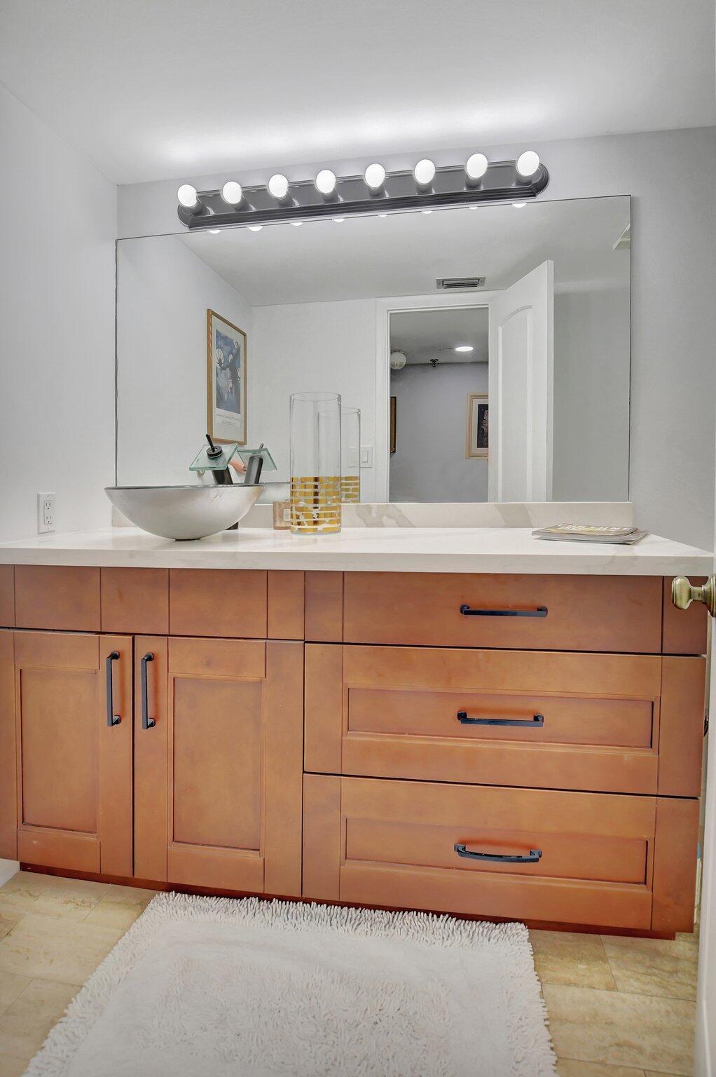 7194 Promenade Drive, Unit 102 Boca Raton, FL 33433 - Photo 20 of 56 a bathroom with a sink double vanity and a mirror