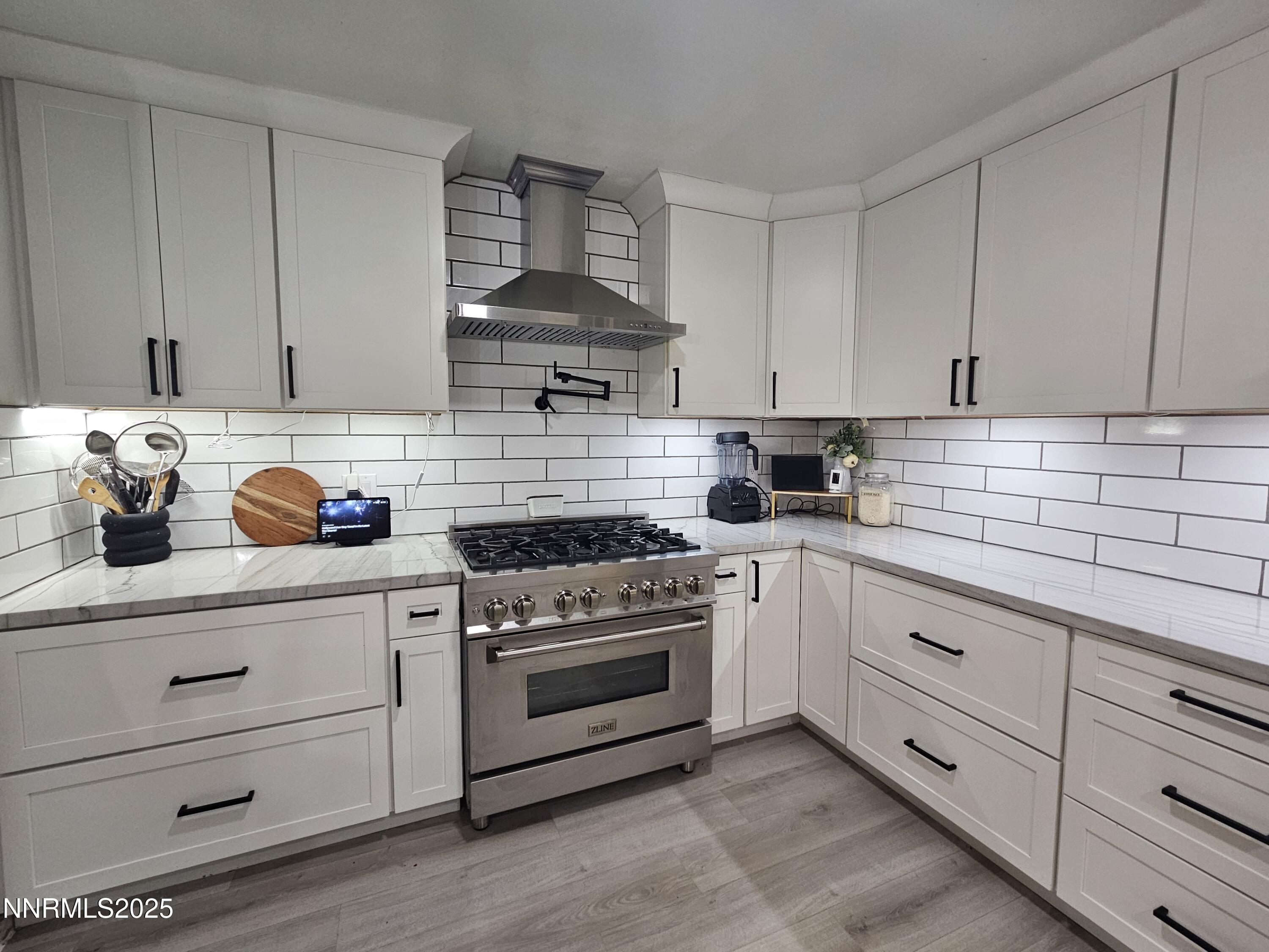 181 Quail Street Sparks, NV 89431 - Photo 13 of 42 a kitchen with white cabinets and white appliances