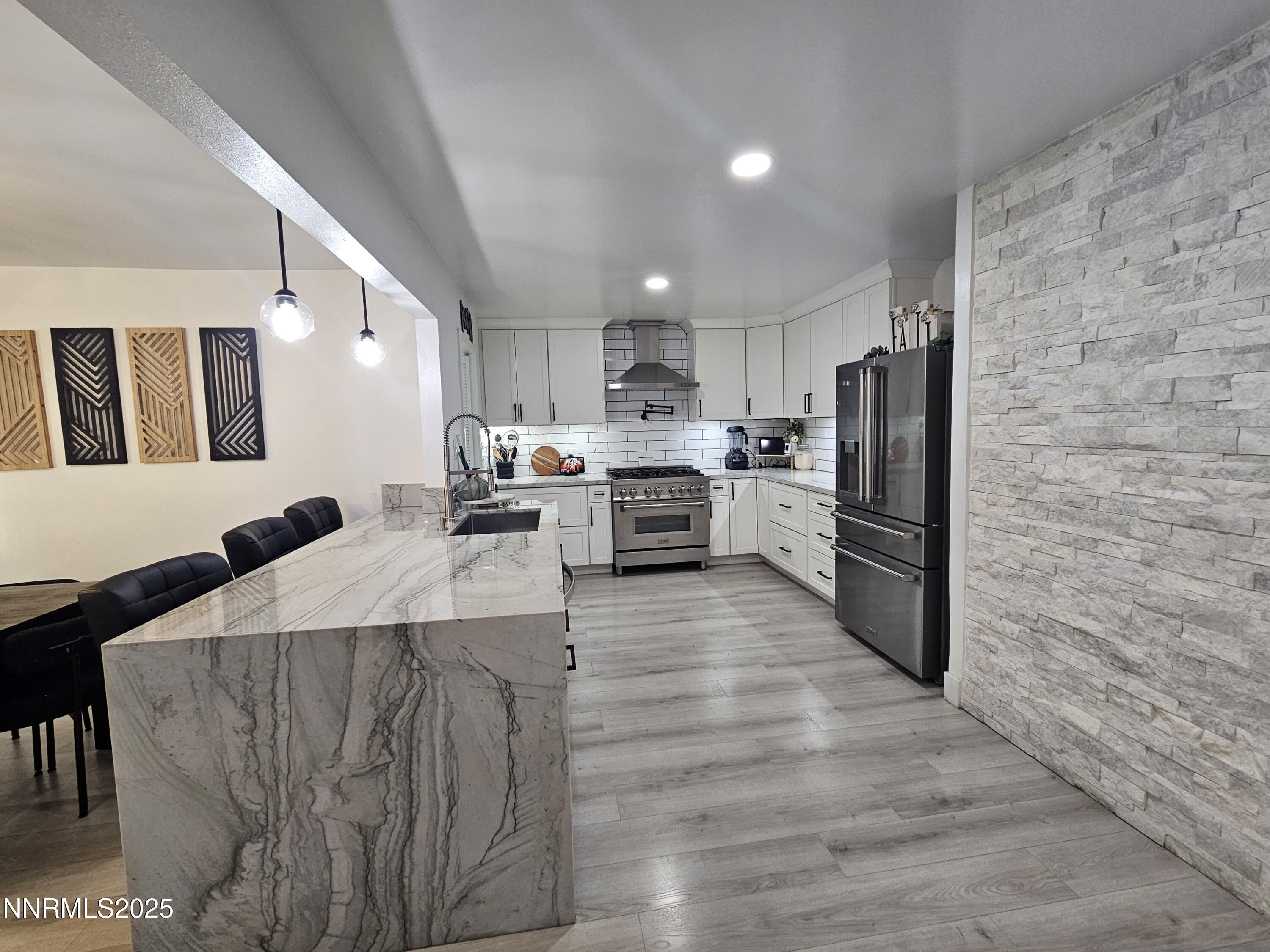 181 Quail Street Sparks, NV 89431 - Photo 15 of 42 a large kitchen with stainless steel appliances kitchen island granite countertop a refrigerator oven a stove with island