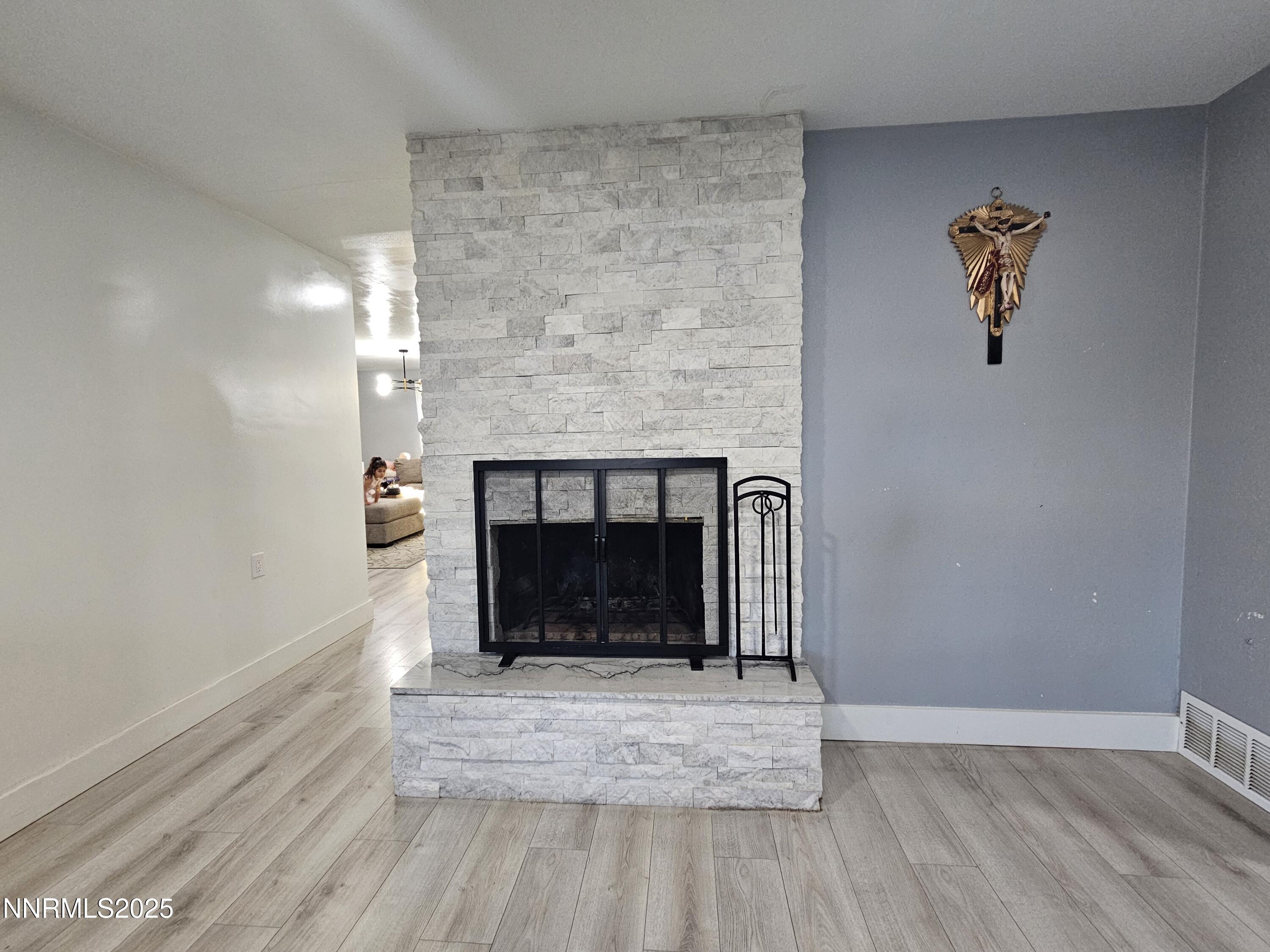 181 Quail Street Sparks, NV 89431 - Photo 23 of 42 a view of an empty room with wooden floor and a fireplace