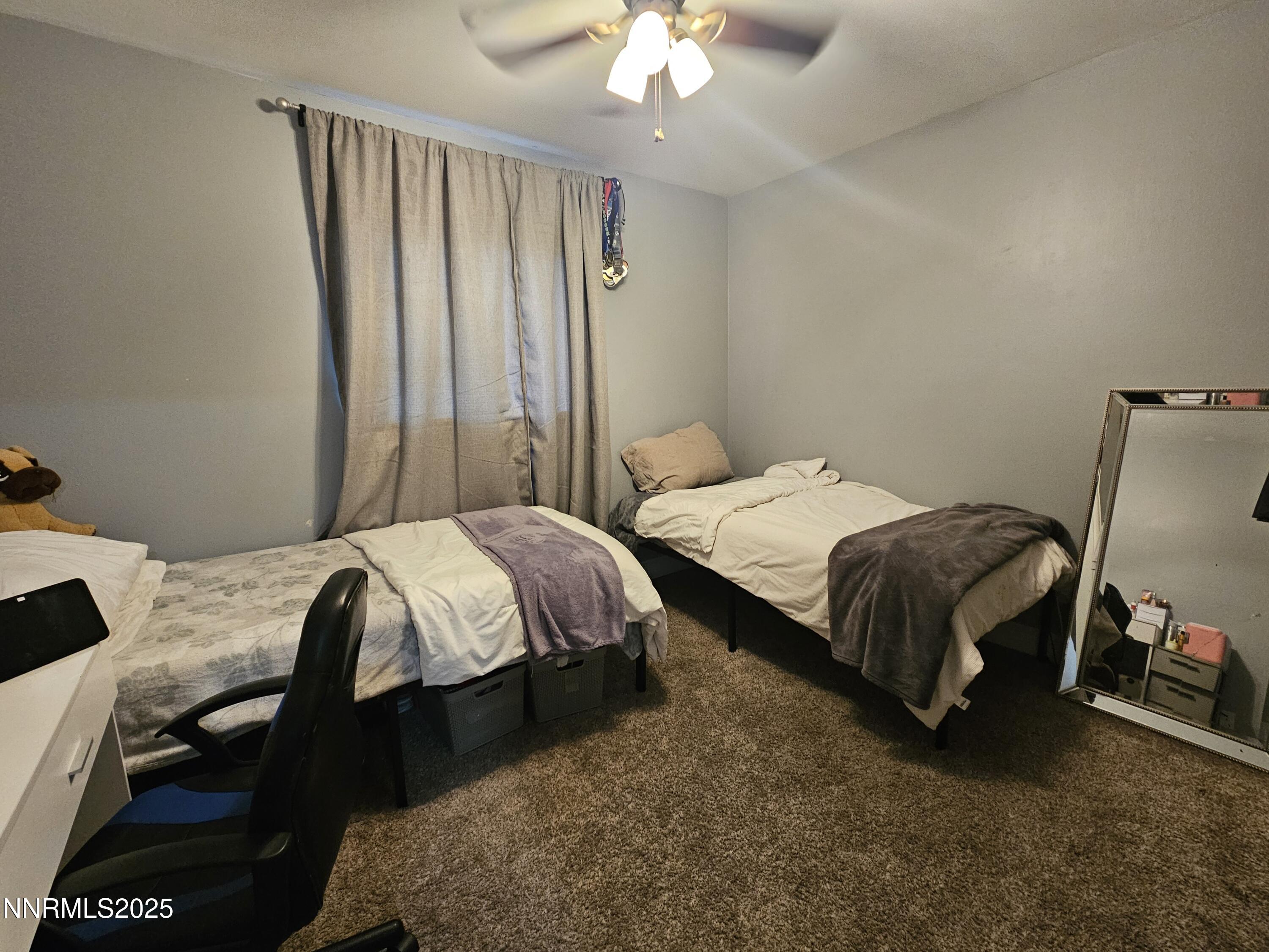 181 Quail Street Sparks, NV 89431 - Photo 26 of 42 a bedroom with a bed and a chandelier
