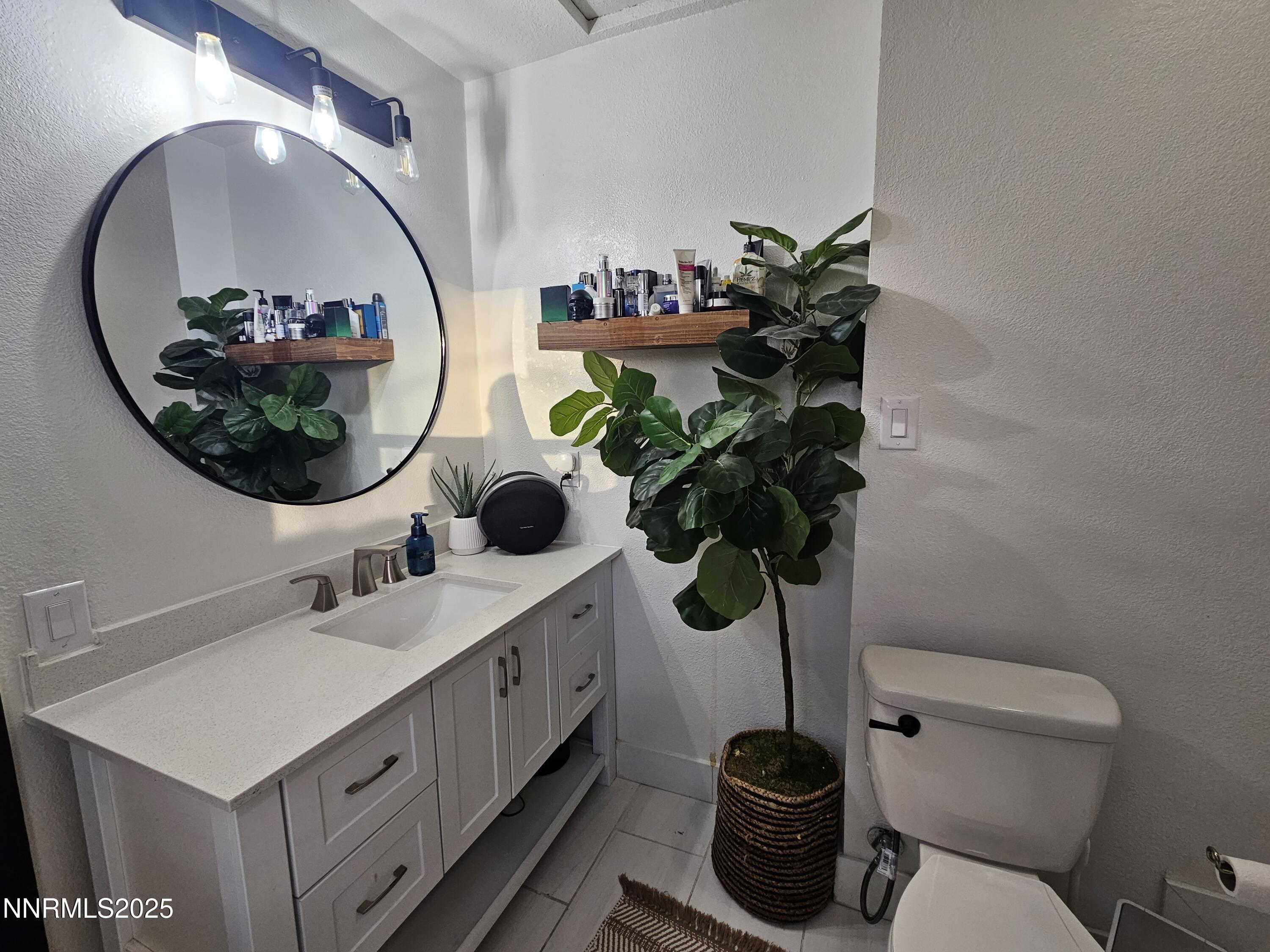 181 Quail Street Sparks, NV 89431 - Photo 27 of 42 a bathroom with a toilet a sink and a mirror