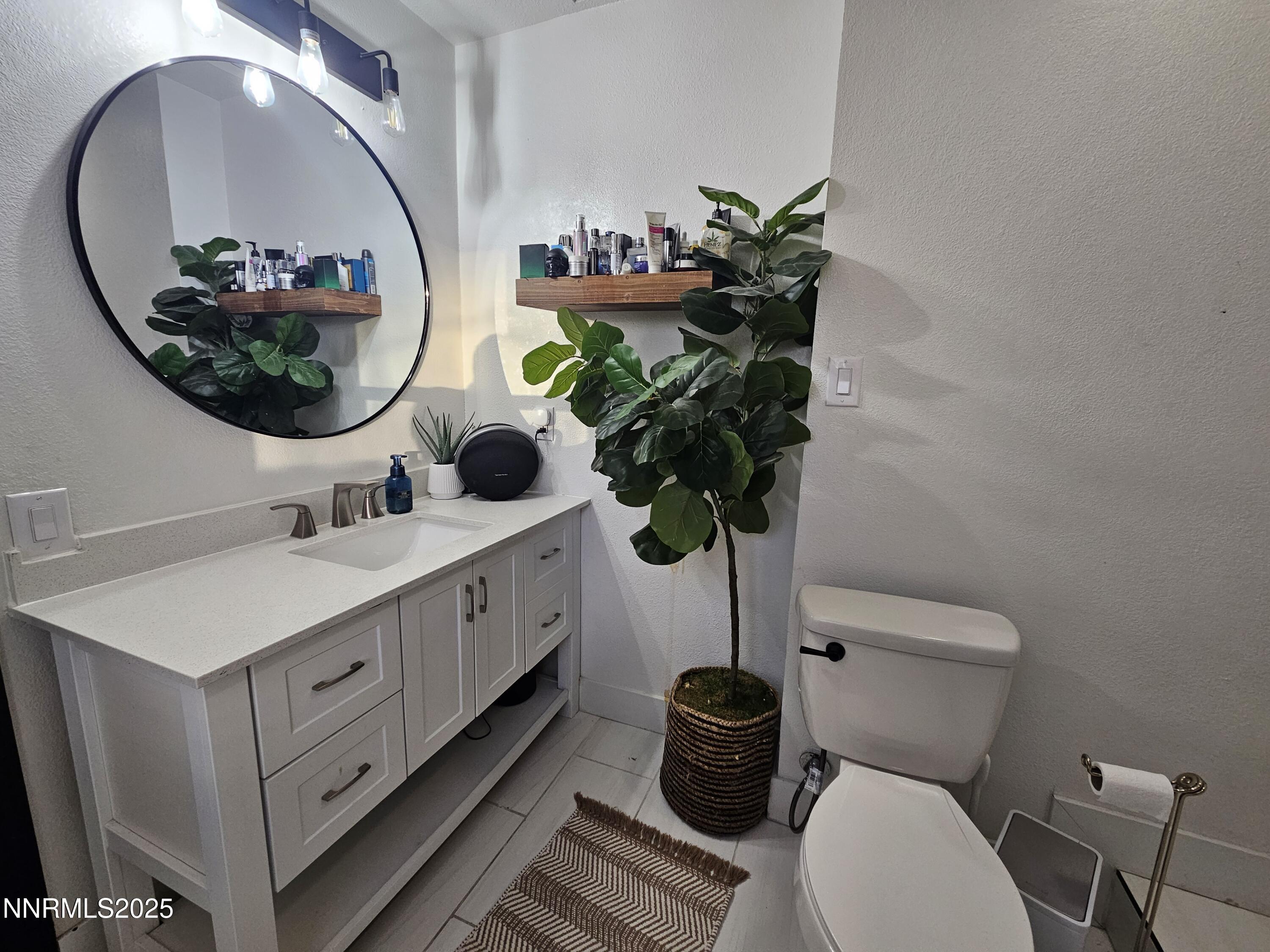 181 Quail Street Sparks, NV 89431 - Photo 28 of 42 a bathroom with a toilet sink and mirror