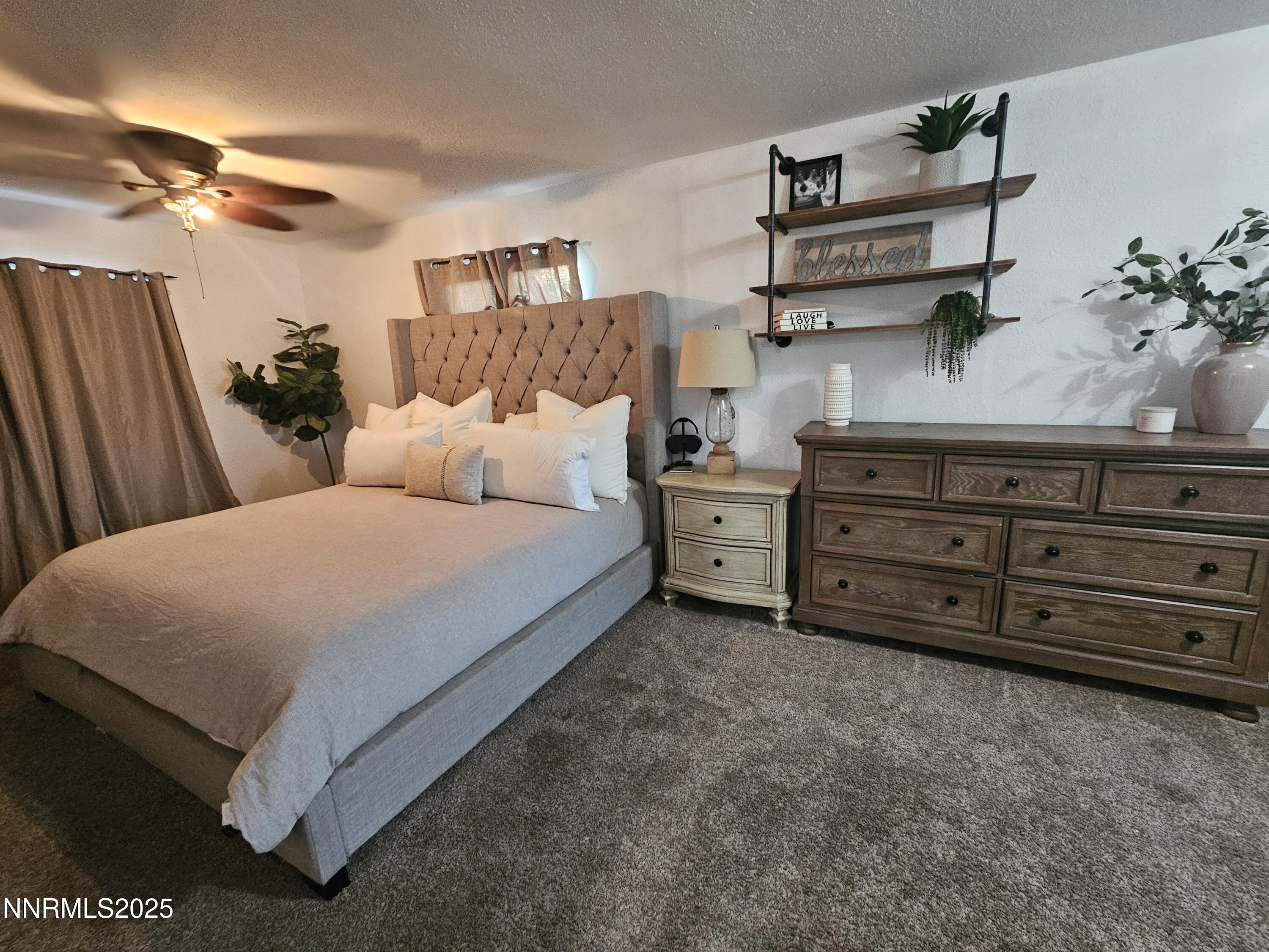 181 Quail Street Sparks, NV 89431 - Photo 33 of 42 a bed room with a bed and a dresser