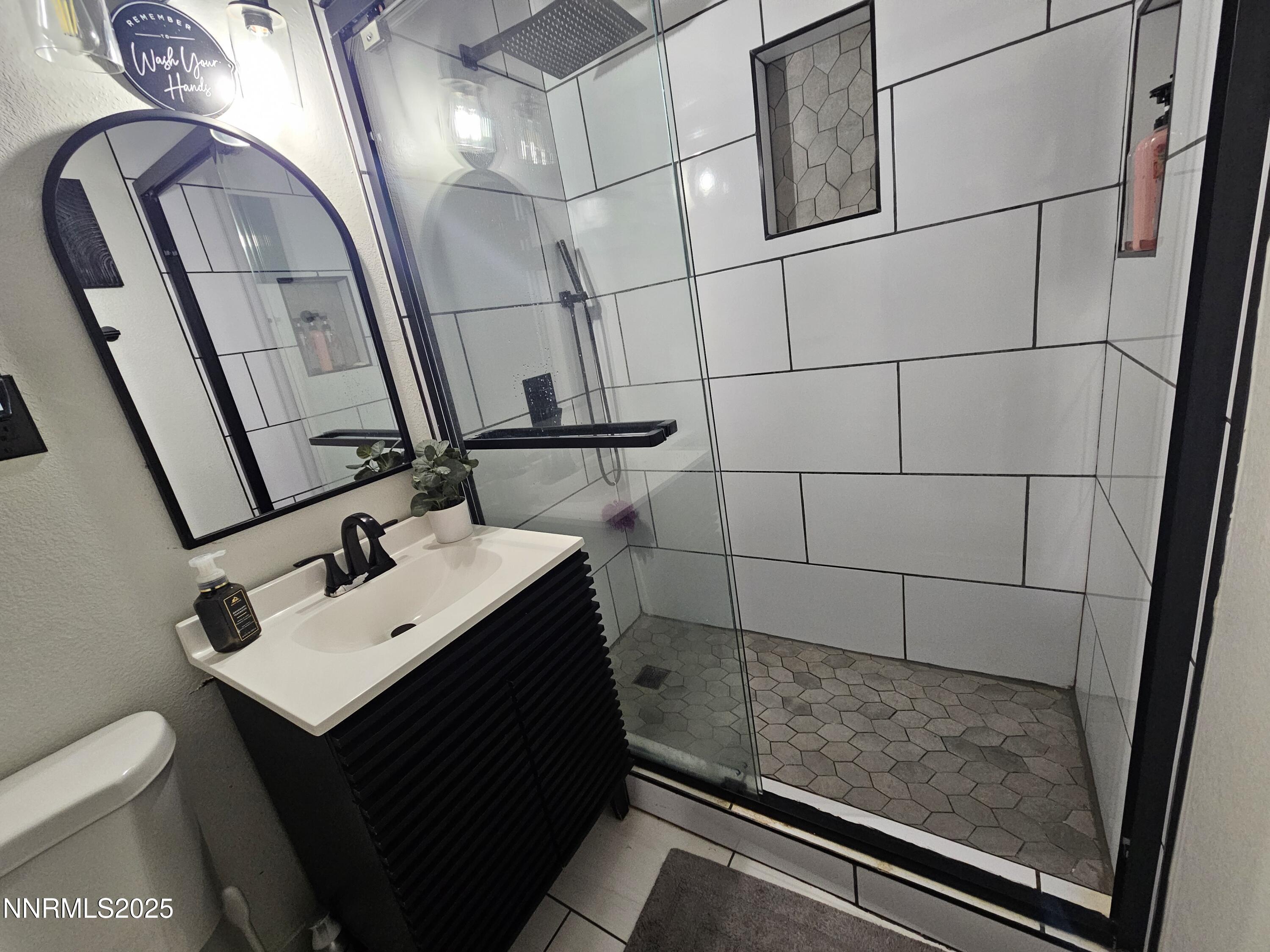 181 Quail Street Sparks, NV 89431 - Photo 34 of 42 a bathroom with a sink toilet and mirror