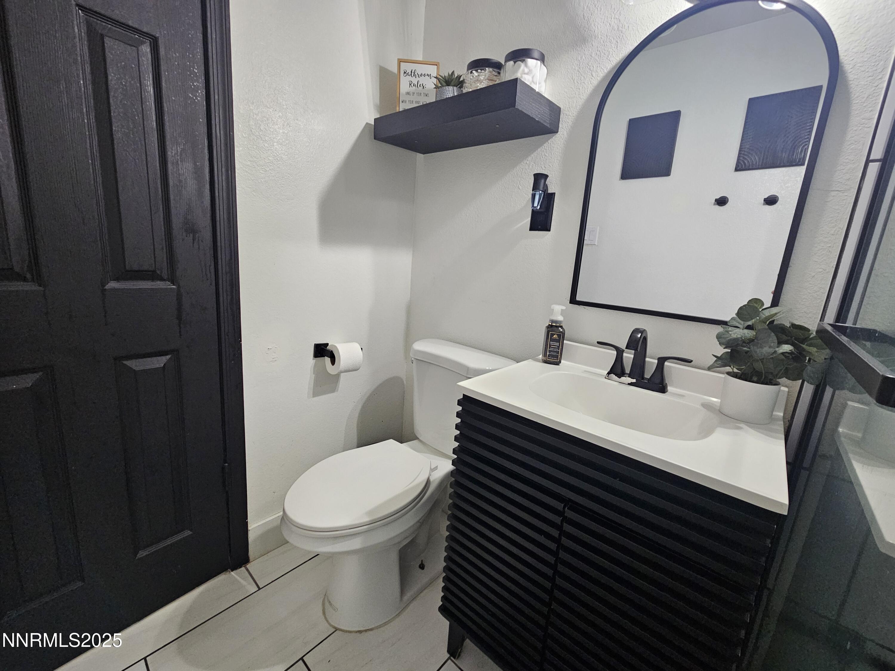 181 Quail Street Sparks, NV 89431 - Photo 35 of 42 a bathroom with a sink toilet and mirror