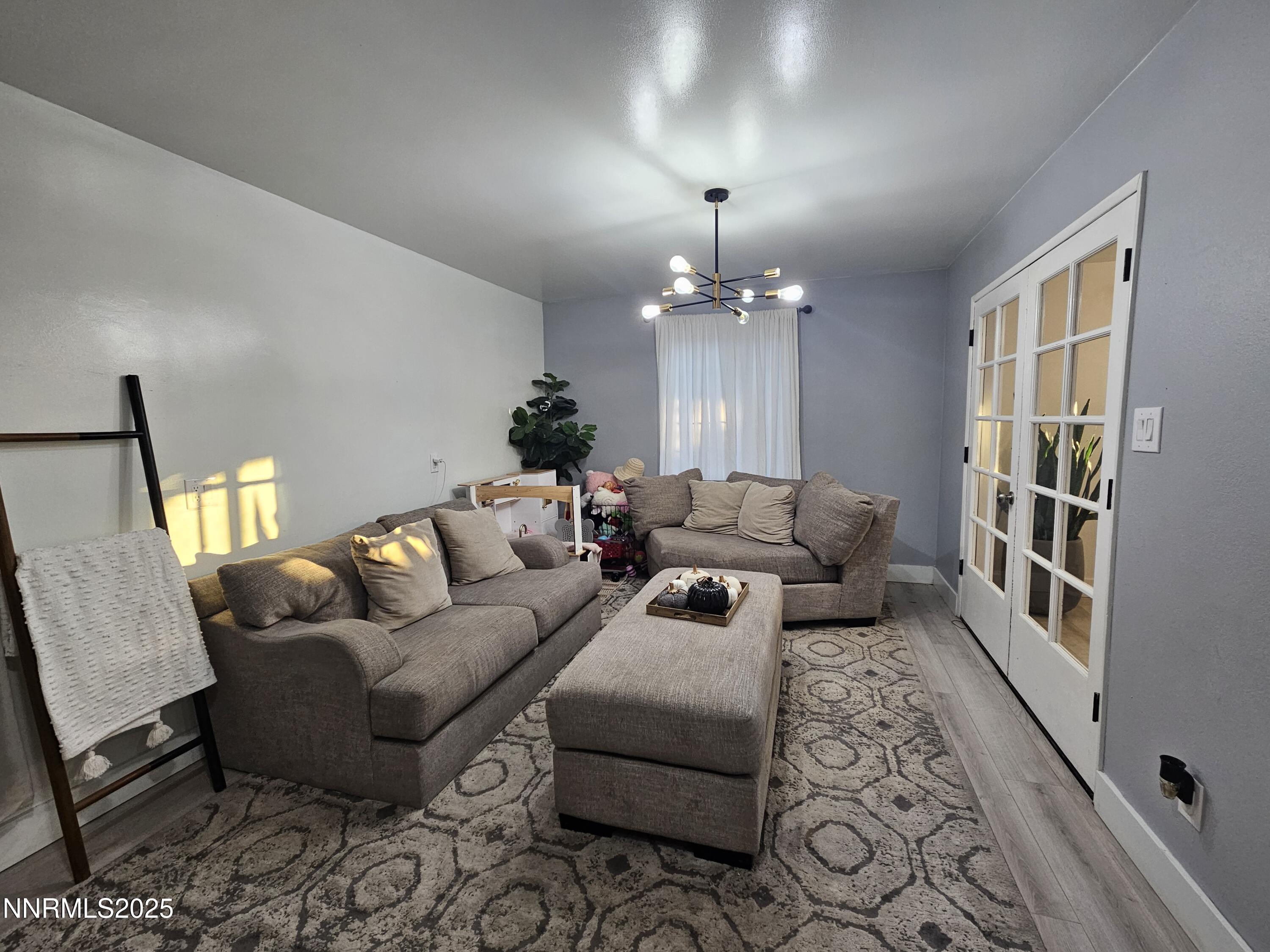 181 Quail Street Sparks, NV 89431 - Photo 8 of 42 a living room with furniture and a chandelier