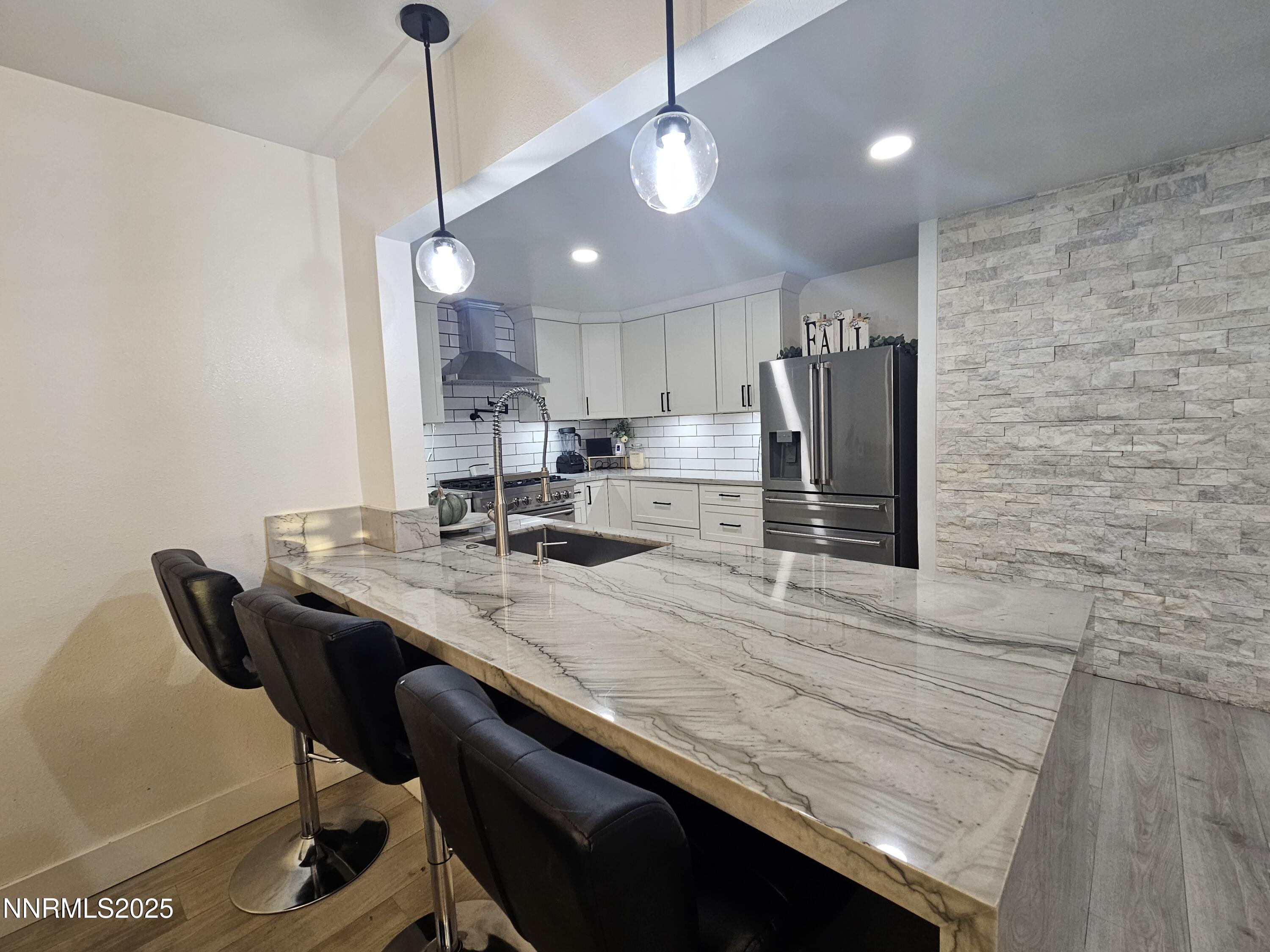 181 Quail Street Sparks, NV 89431 - Photo 9 of 42 a kitchen with a table chairs refrigerator and microwave