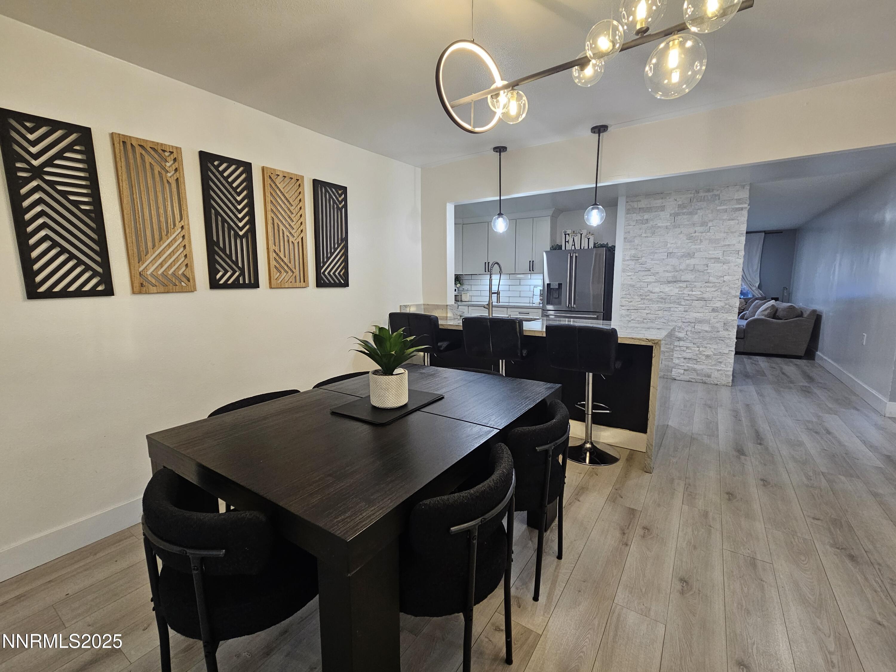 181 Quail Street Sparks, NV 89431 - Photo 10 of 42 a view of a dining room with furniture and wooden floor