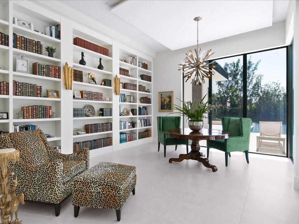 172 Center Street Naples, FL 34108 - Photo 14 of 50 a living room with furniture and a floor to ceiling window