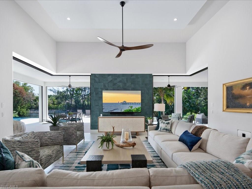172 Center Street Naples, FL 34108 - Photo 19 of 50 a living room with furniture flat screen tv and a large window
