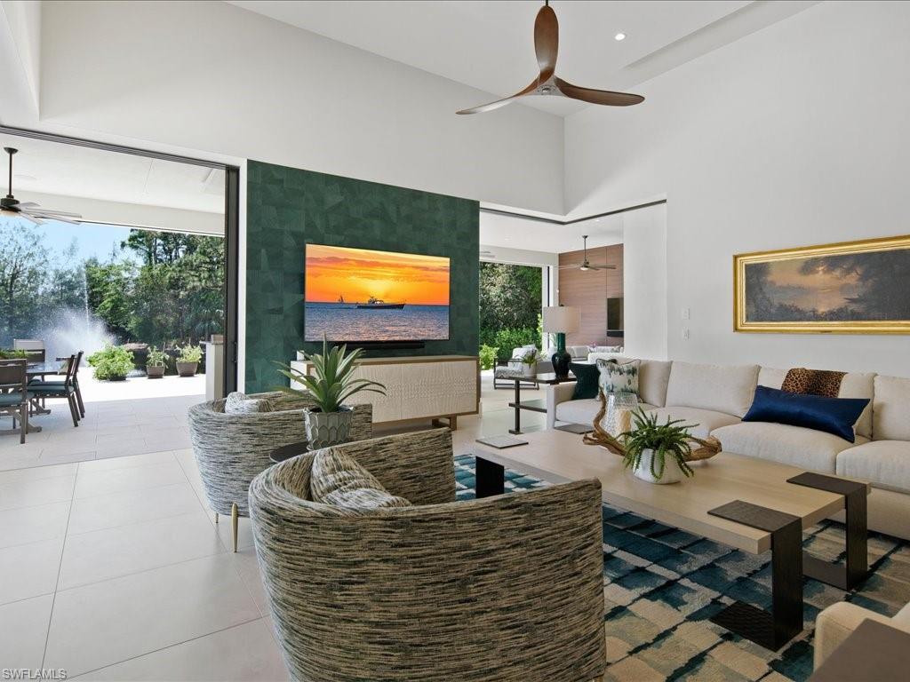 172 Center Street Naples, FL 34108 - Photo 20 of 50 a living room with patio furniture and a flat screen tv
