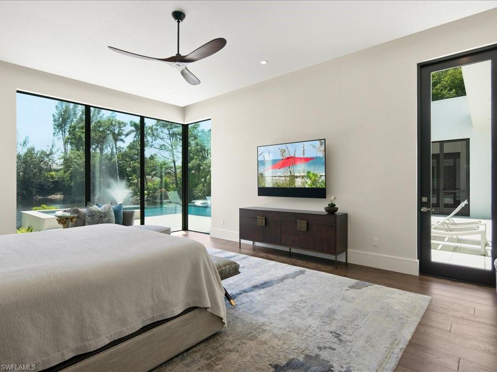 172 Center Street Naples, FL 34108 - Photo 24 of 50 a bedroom with a bed and a flat screen tv