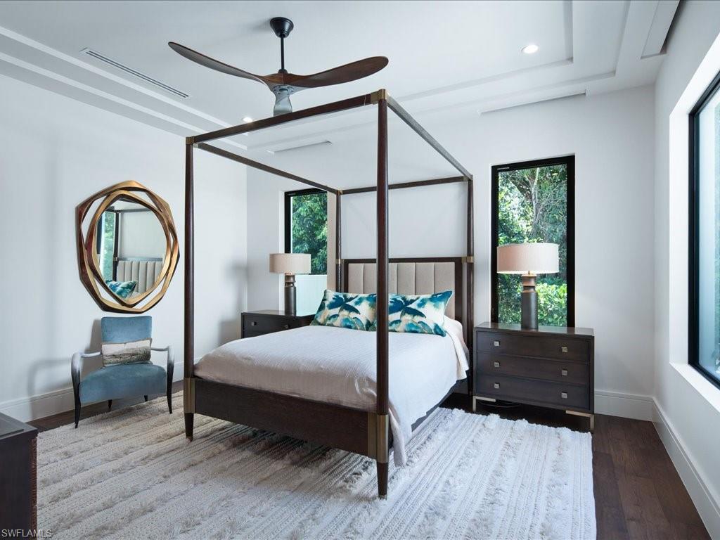172 Center Street Naples, FL 34108 - Photo 30 of 50 a bedroom with a bed a mirror and window