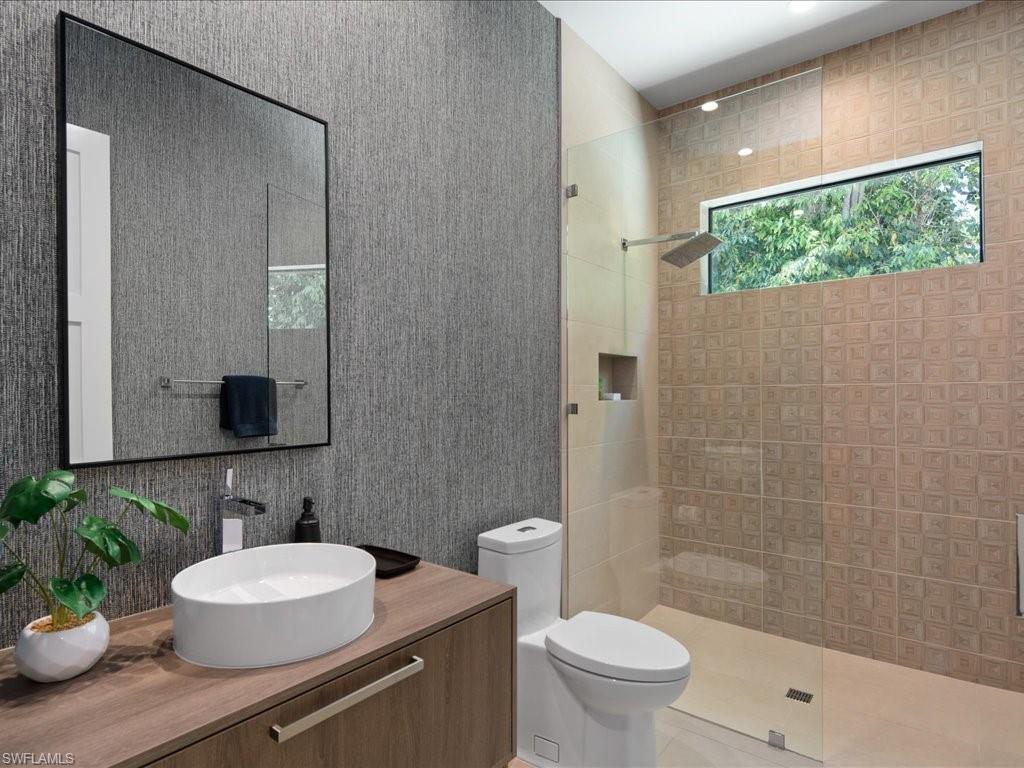 172 Center Street Naples, FL 34108 - Photo 31 of 50 a bathroom with a sink toilet a mirror and shower