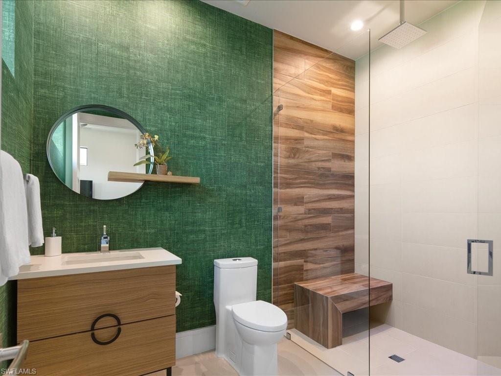 172 Center Street Naples, FL 34108 - Photo 33 of 50 a bathroom with a toilet sink and mirror