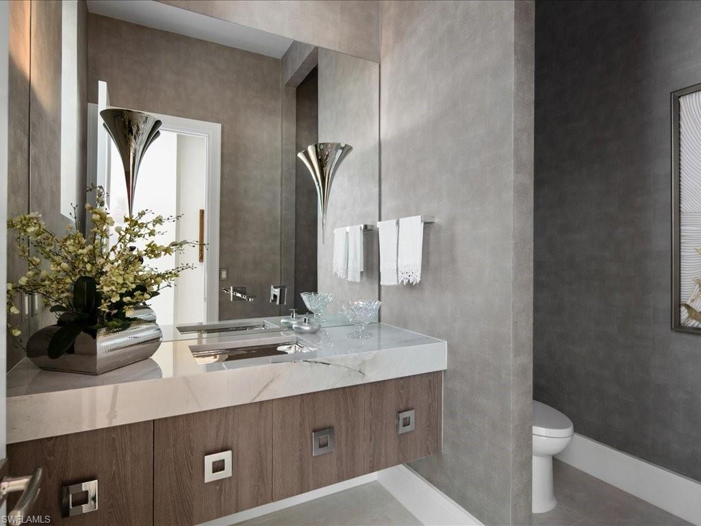 172 Center Street Naples, FL 34108 - Photo 34 of 50 a bathroom with a sink and a mirror