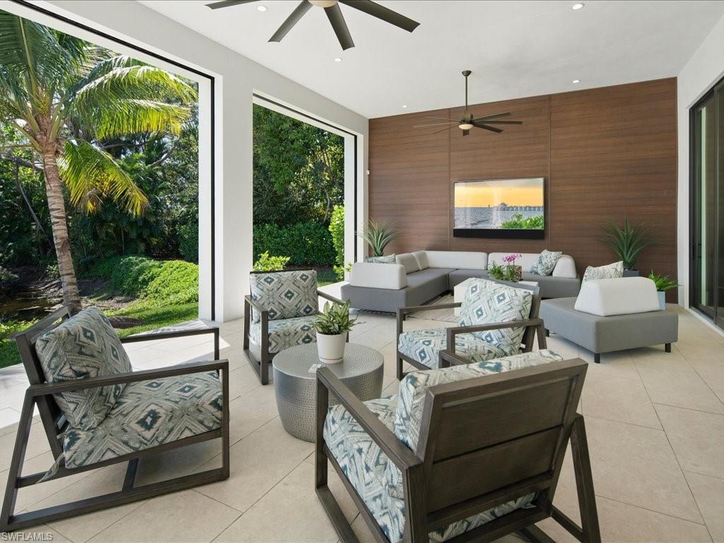172 Center Street Naples, FL 34108 - Photo 38 of 50 a living room with furniture and a flat screen tv