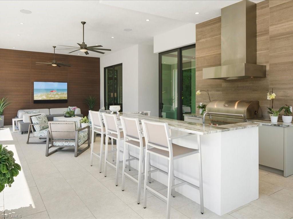 172 Center Street Naples, FL 34108 - Photo 39 of 50 a kitchen with a sink table and chairs
