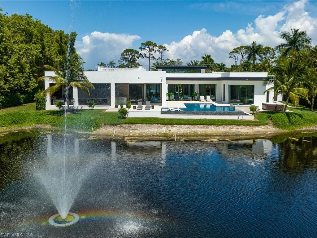 172 Center Street Naples, FL 34108 - Photo 48 of 50 a front view of house with outdoor seating swimming pool and outdoor seating