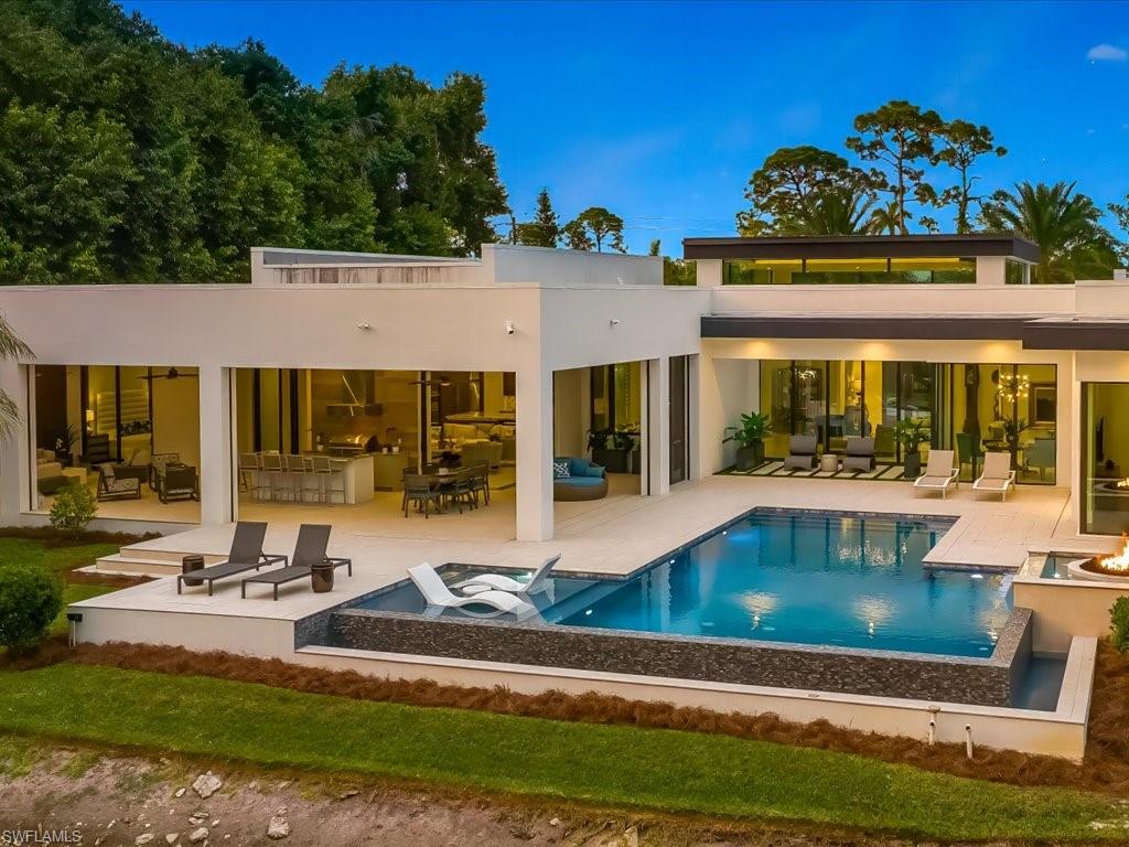 172 Center Street Naples, FL 34108 - Photo 7 of 50 a view of a house with swimming pool and sitting area