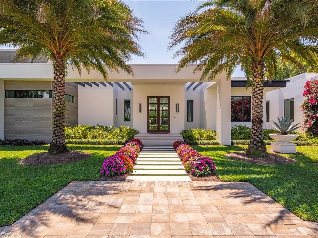 172 Center Street Naples, FL 34108 - Photo 9 of 50 a view of house with garden and tall trees