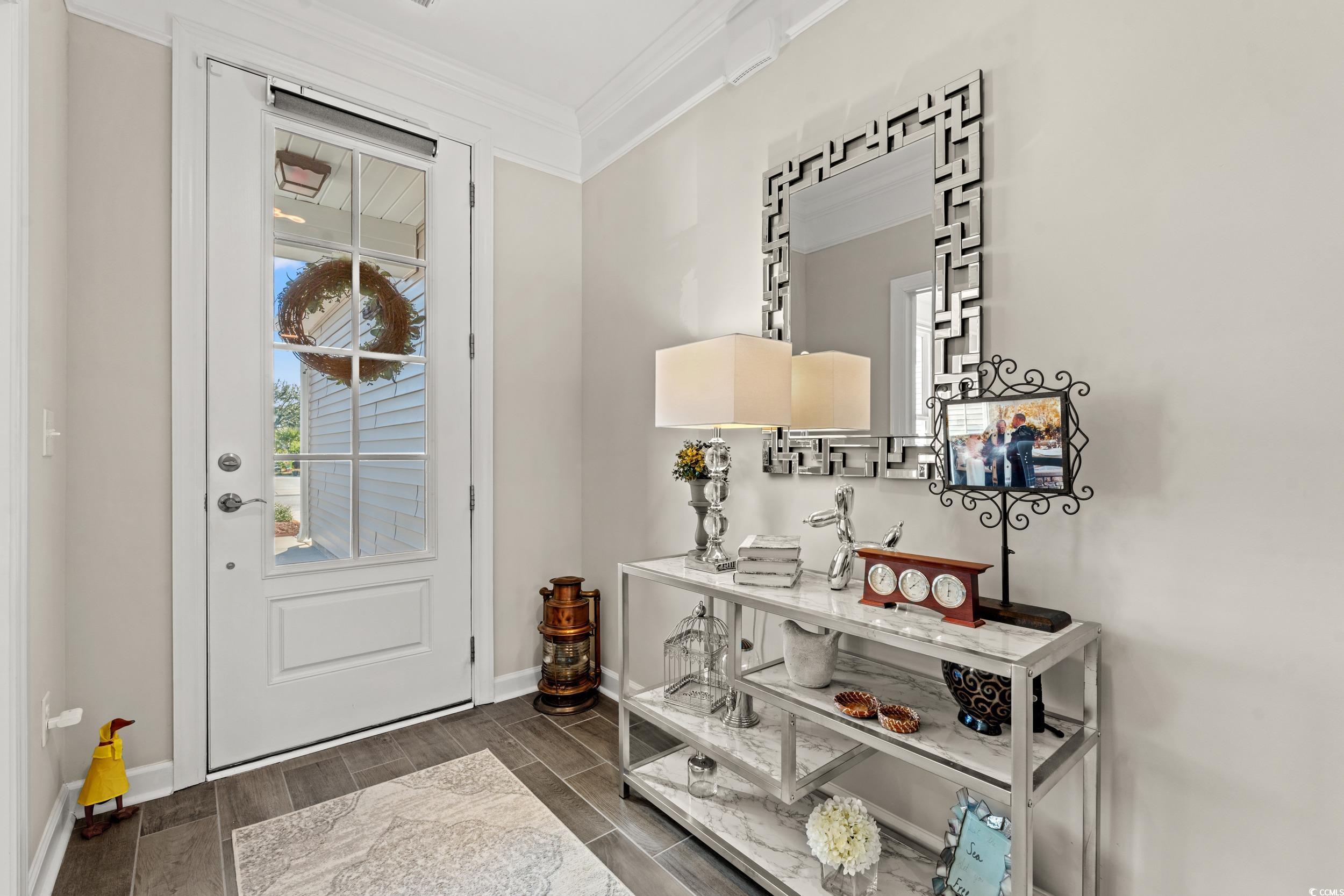 457 Cascade Loop Little River, SC 29566 - Photo 2 of 40 Foyer entrance with crown molding and dark hardwoo