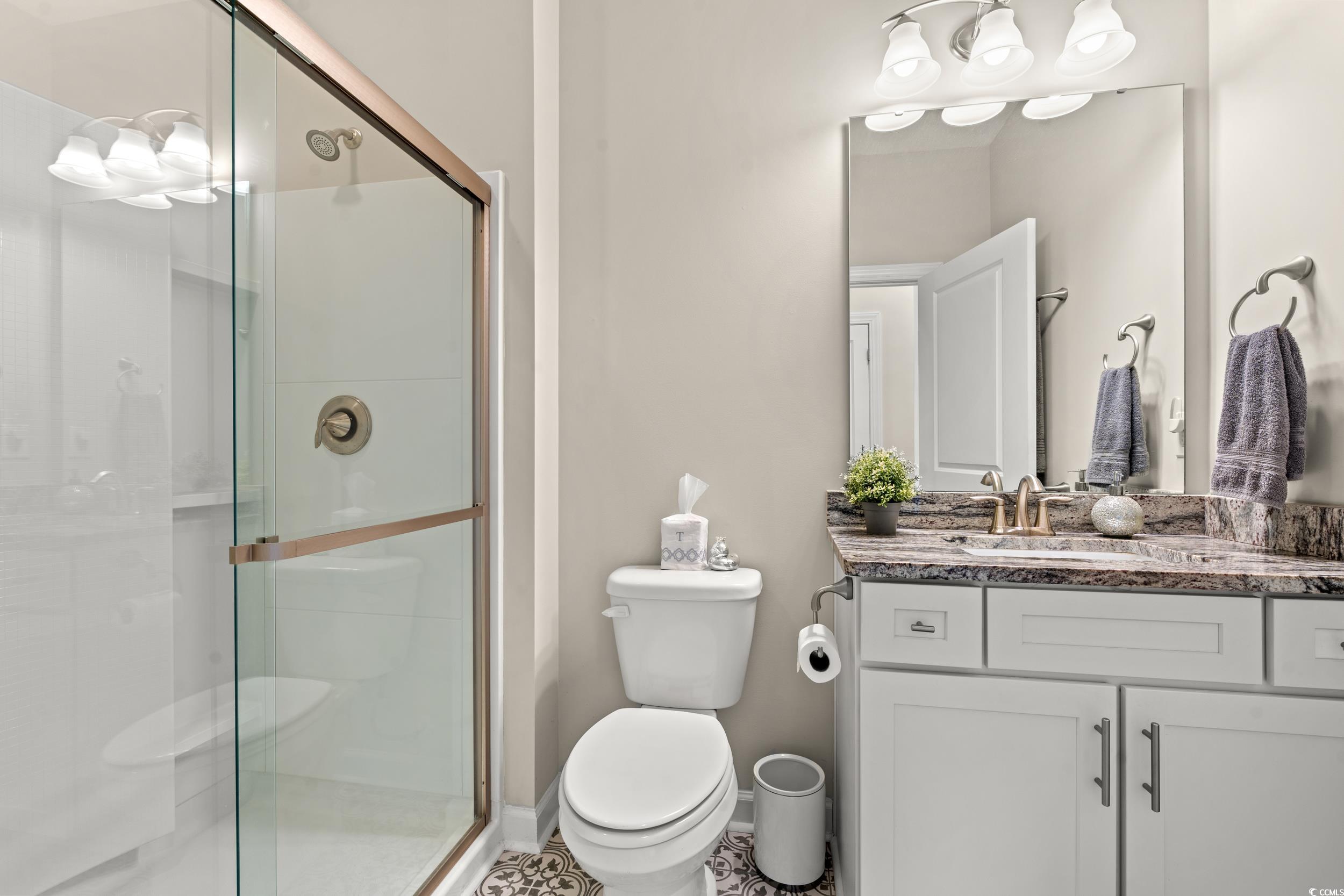 457 Cascade Loop Little River, SC 29566 - Photo 21 of 40 Bathroom with tile patterned floors, toilet, vanit