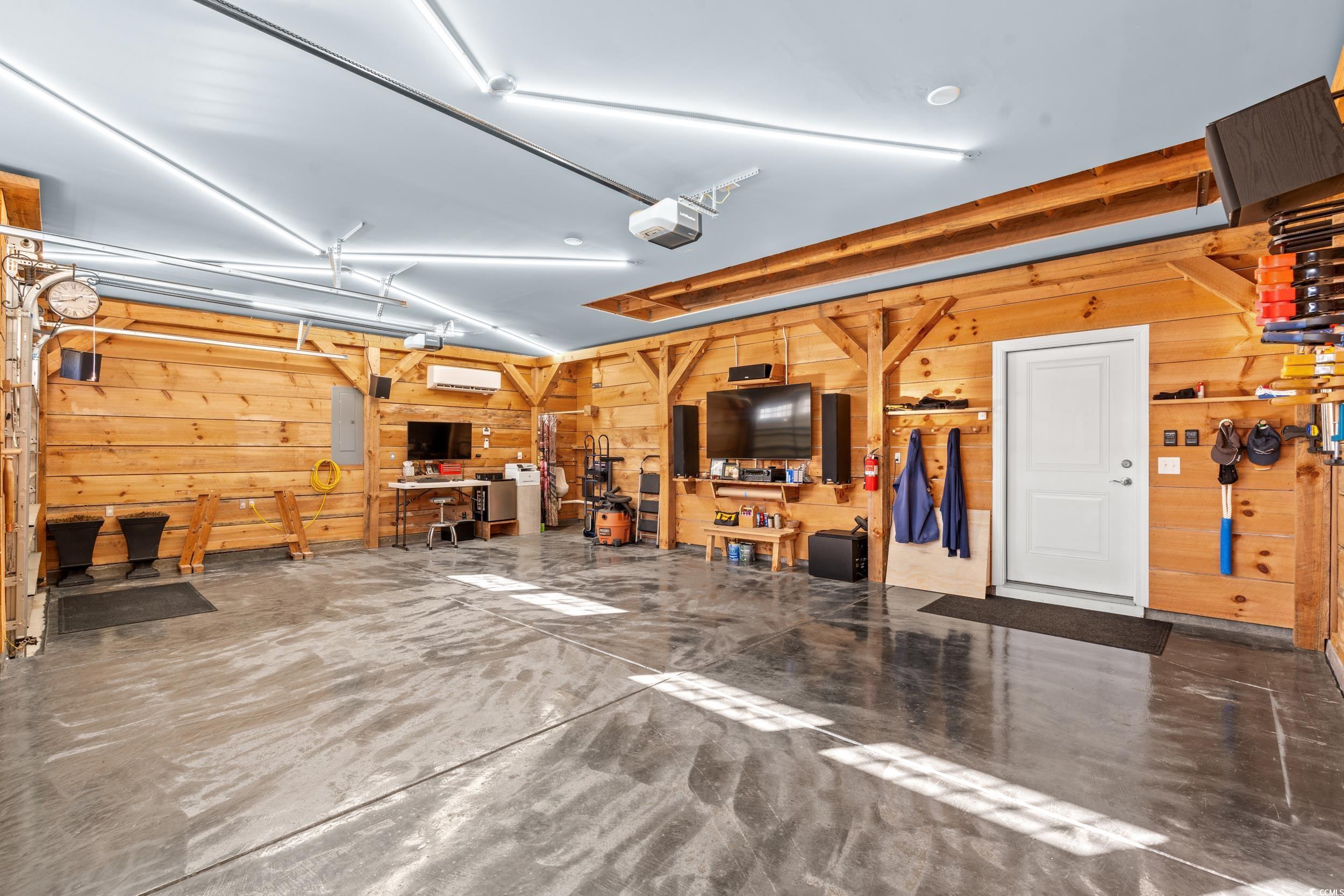 457 Cascade Loop Little River, SC 29566 - Photo 26 of 40 Garage with a workshop area, electric panel, a gar