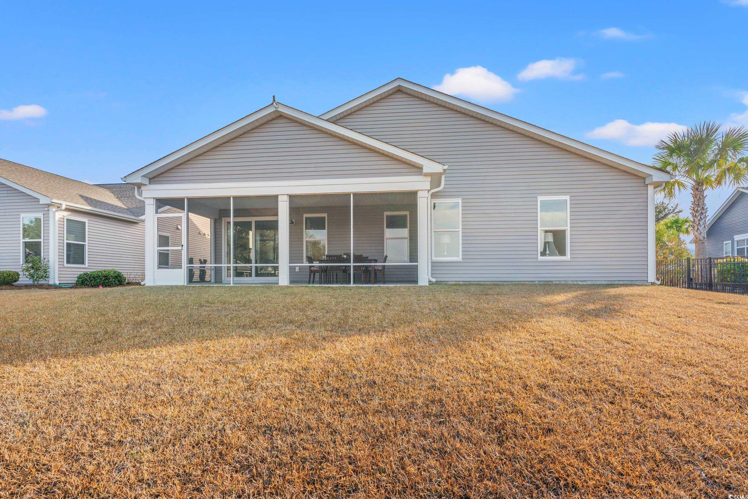 457 Cascade Loop Little River, SC 29566 - Photo 32 of 40 Back of property with a yard and a sunroom