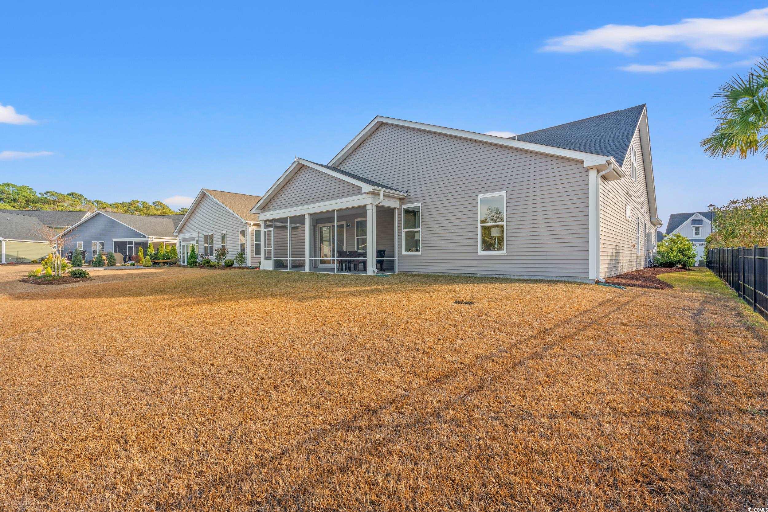 457 Cascade Loop Little River, SC 29566 - Photo 33 of 40 Back of property featuring a sunroom and a lawn