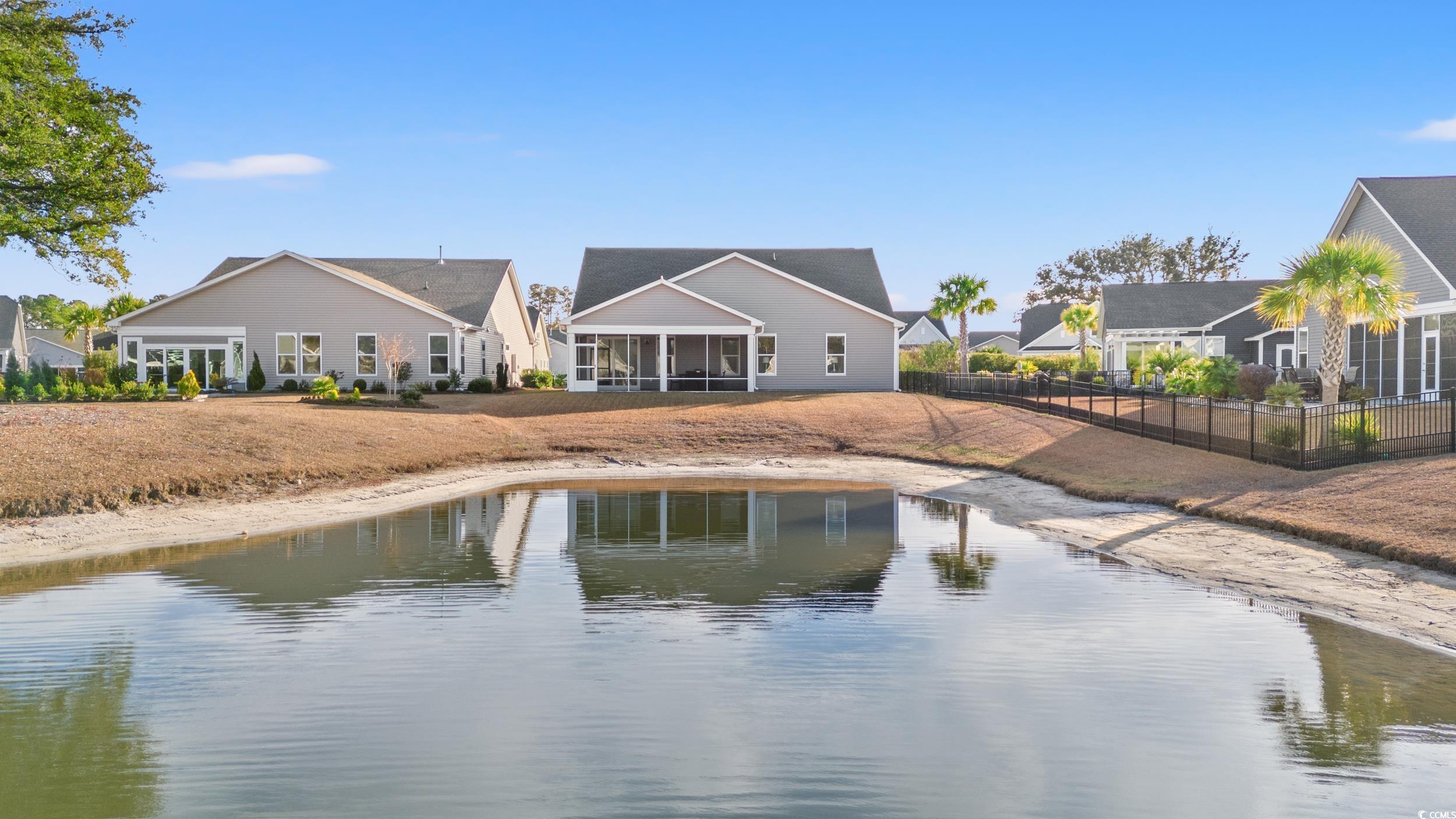 457 Cascade Loop Little River, SC 29566 - Photo 39 of 40 Back of house featuring a sunroom and a water view