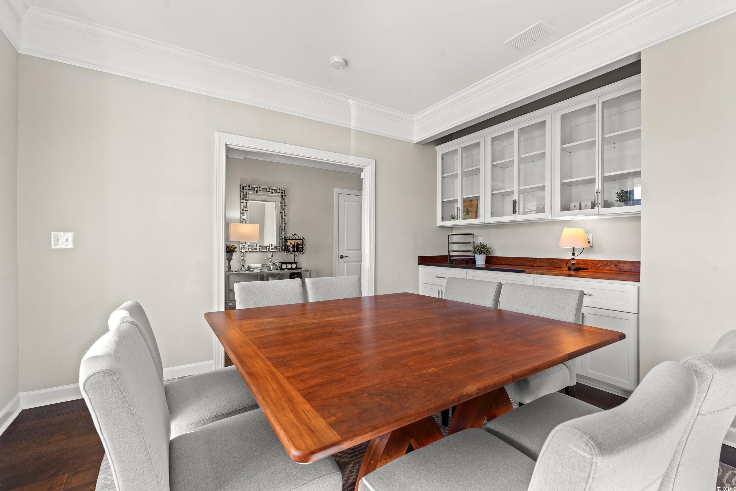 457 Cascade Loop Little River, SC 29566 - Photo 4 of 40 Dining space featuring crown molding and dark wood