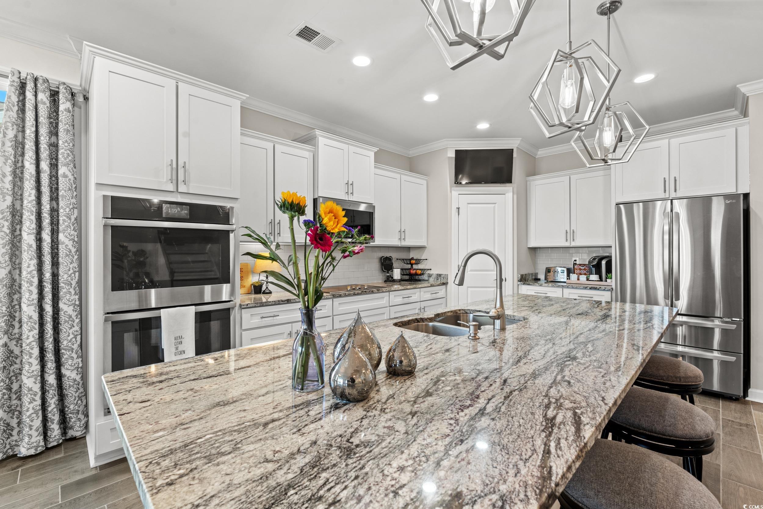 457 Cascade Loop Little River, SC 29566 - Photo 5 of 40 Kitchen with sink, light hardwood / wood-style flo