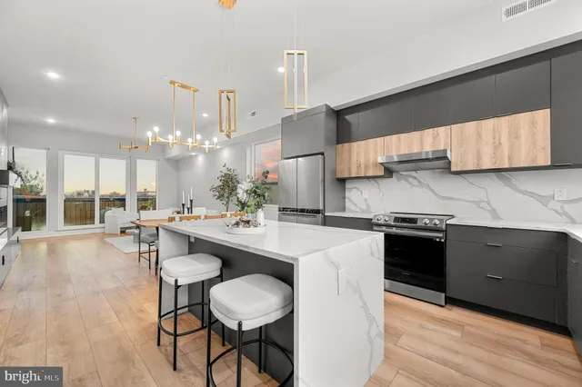 a kitchen with stainless steel appliances kitchen island granite countertop a sink and cabinets