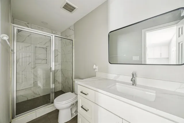 a bathroom with a sink toilet and shower