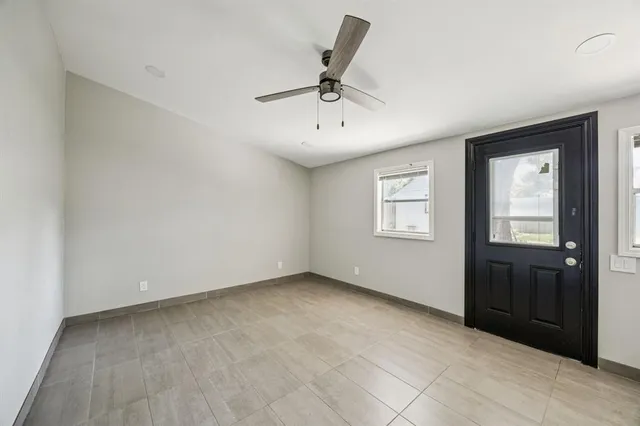 an empty room with windows and closet