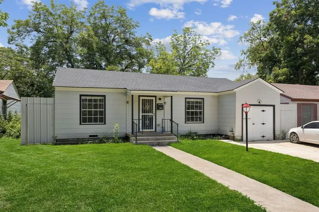 a view of a house with a yard and garden