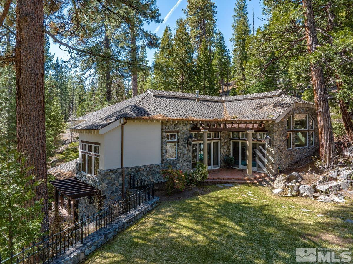 190 Yellow Jacket Road Glenbrook, NV 89413 - Photo 24 of 42 a view of a house with a yard patio and fire pit