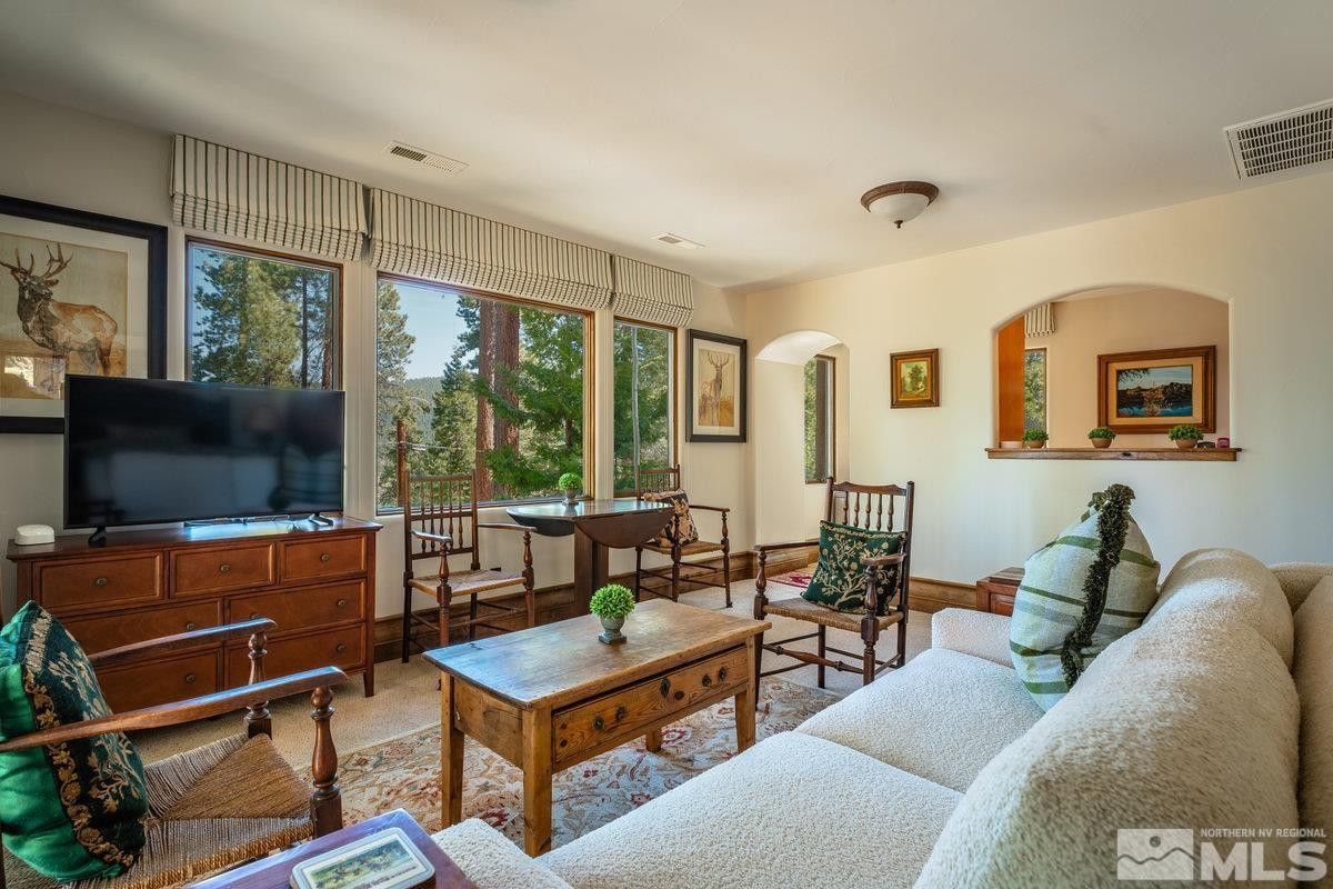 190 Yellow Jacket Road Glenbrook, NV 89413 - Photo 29 of 42 a living room with furniture a flat screen tv and floor to ceiling window