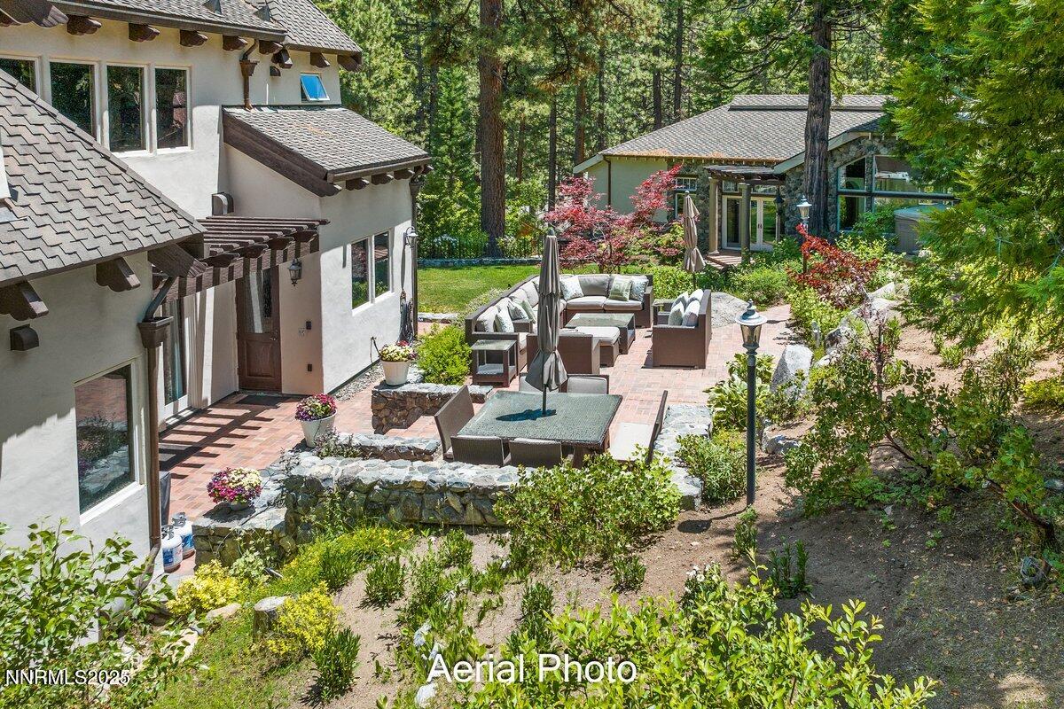190 Yellow Jacket Road Glenbrook, NV 89413 - Photo 32 of 42 a view of a house with a yard and lawn chairs under an umbrella
