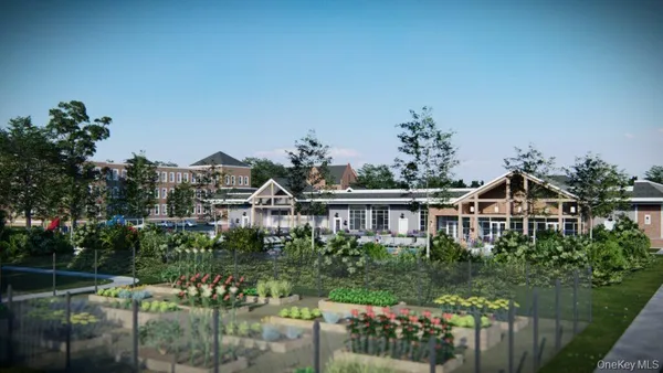 a front view of a house with a yard table and chairs