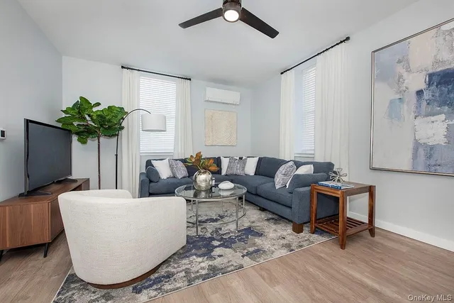 a living room with furniture a dining table and a fireplace