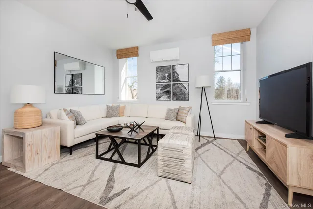 a living room with furniture and a potted plant