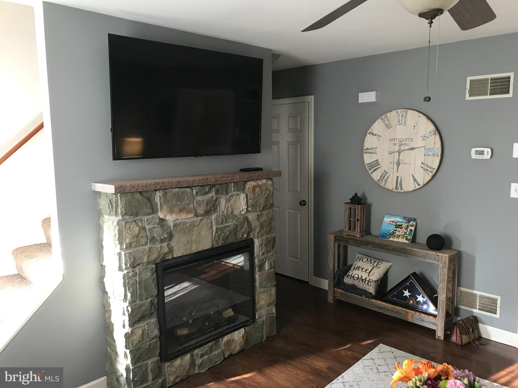195 River Road Pequea, PA 17565 - Photo 11 of 77 a living room with furniture a flat screen tv and a fireplace