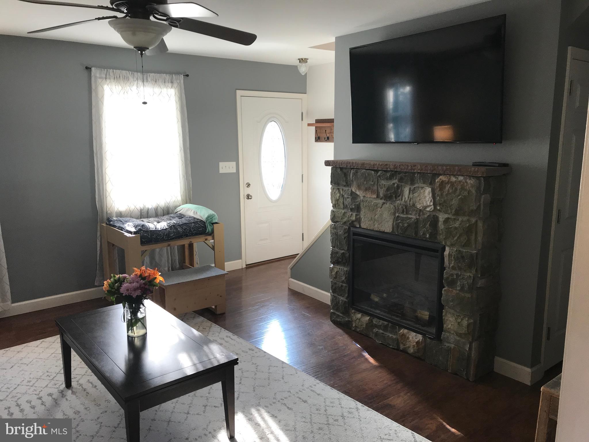 195 River Road Pequea, PA 17565 - Photo 15 of 77 a living room with furniture a flat screen tv and a fireplace