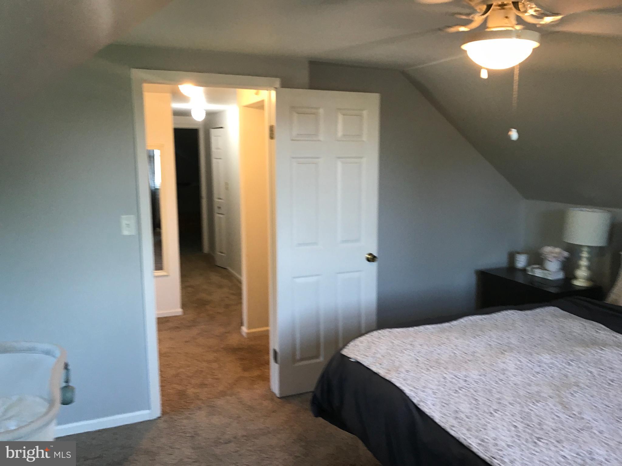 195 River Road Pequea, PA 17565 - Photo 42 of 77 a bedroom with a bed and a chandelier