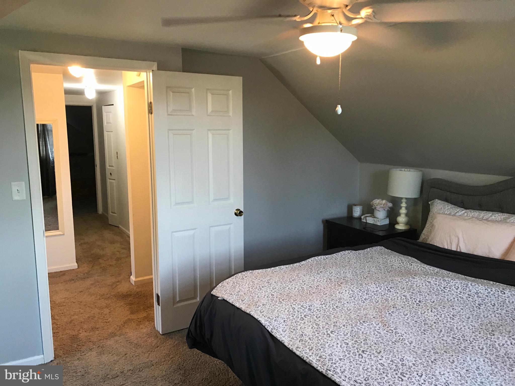 195 River Road Pequea, PA 17565 - Photo 45 of 77 a bedroom with a bed and a chandelier