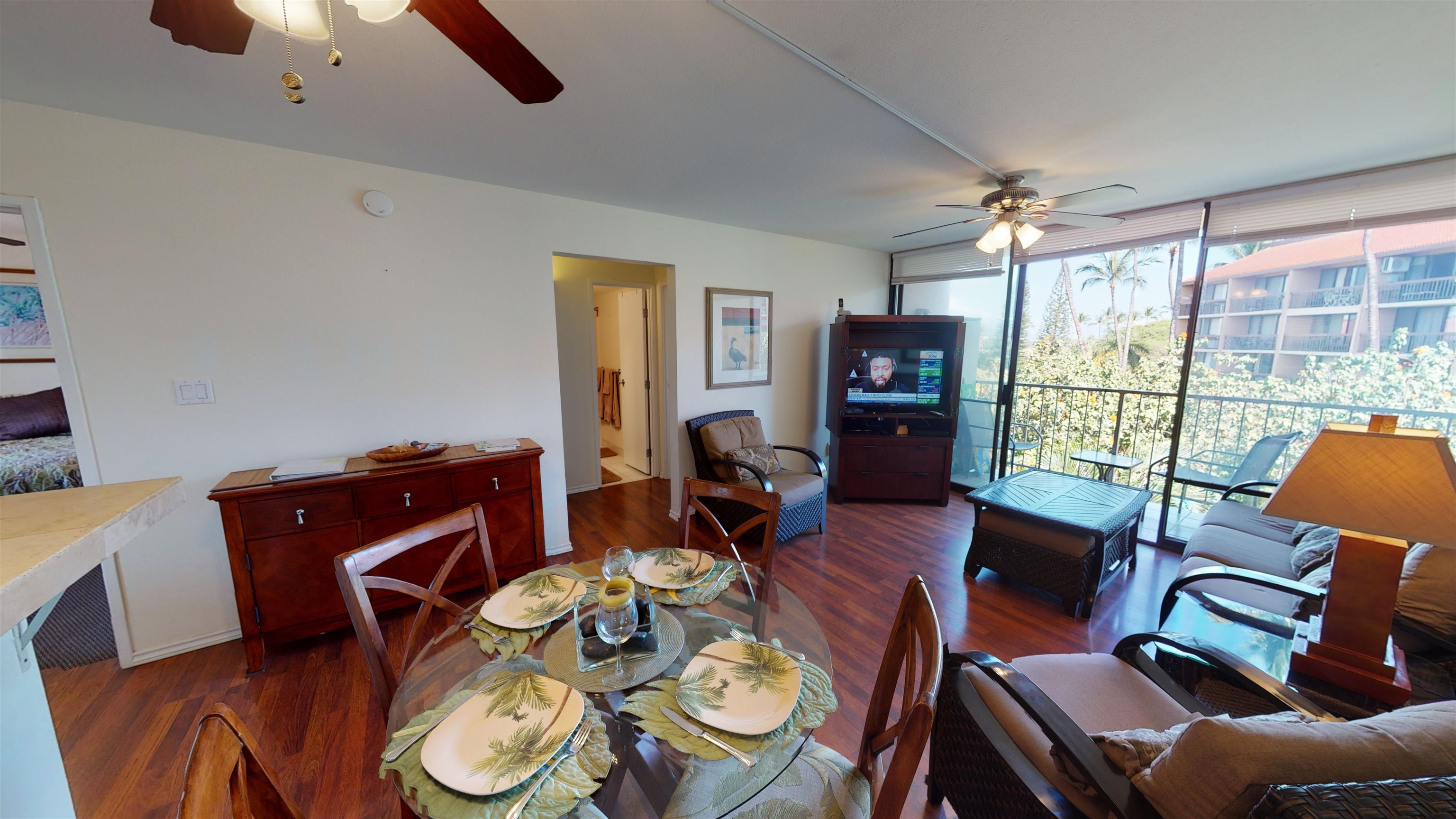2219 South Kihei Road, Unit A408 Kihei, HI 96753 - Photo 12 of 30 a view of a dining room with furniture a chandelier and wooden floor
