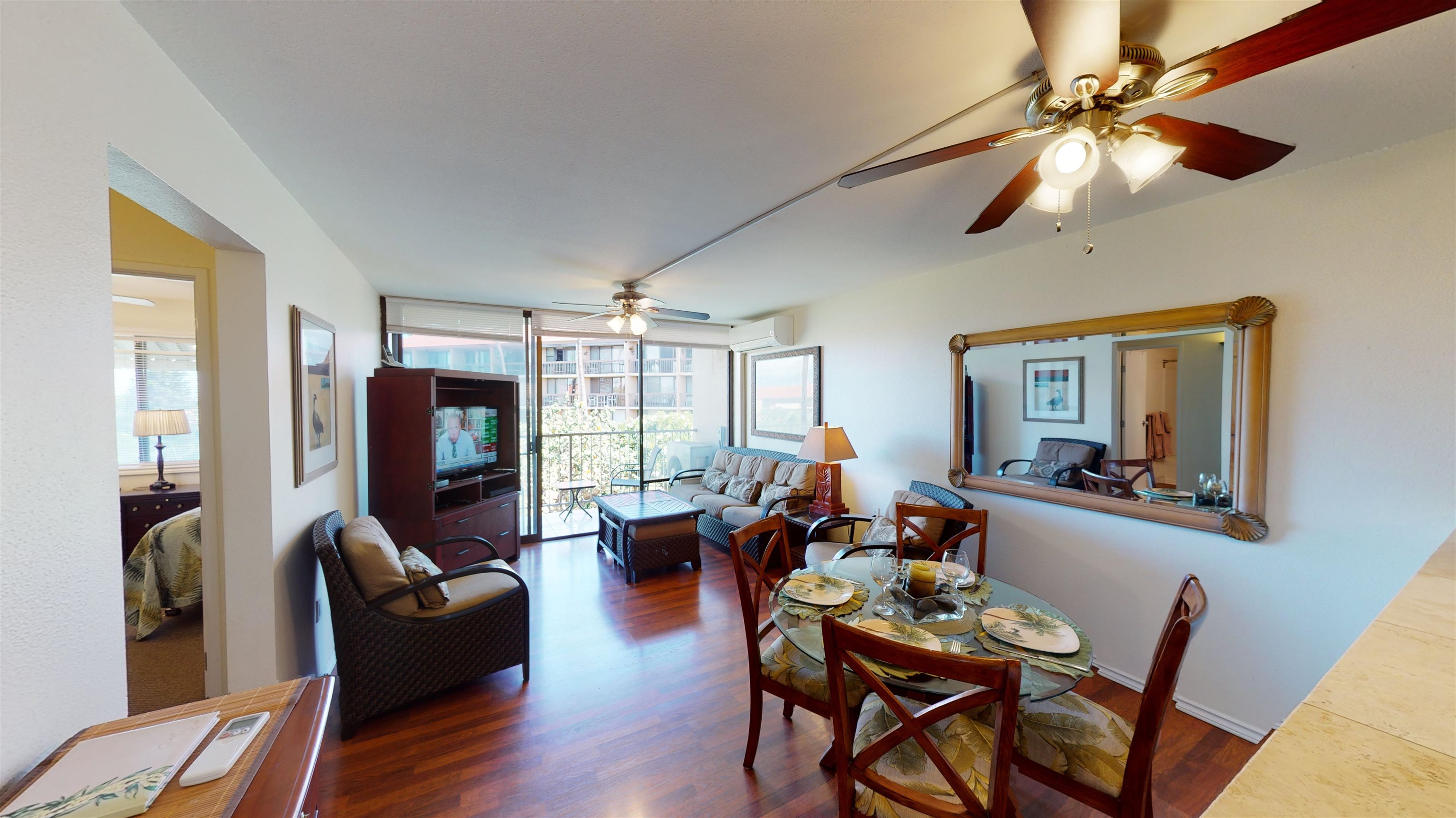 2219 South Kihei Road, Unit A408 Kihei, HI 96753 - Photo 13 of 30 a living room with furniture a flat screen tv and a large window